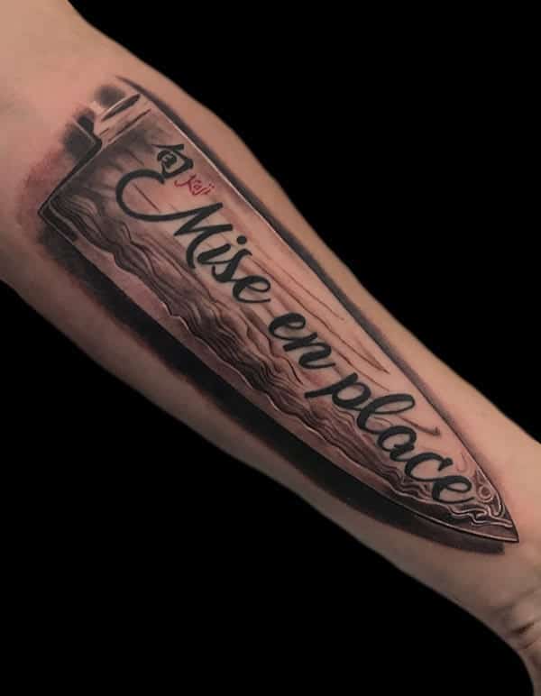 knife and lettering tattoo