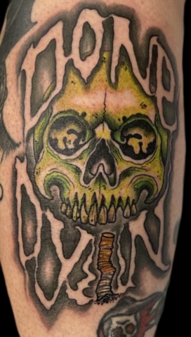 skull and lettering tattoo