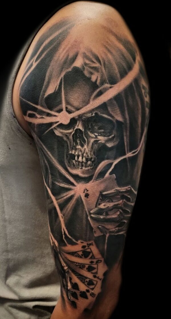 Realistic playing card reaper skull tattoo