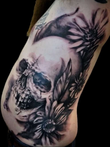 Realistic large skull rib piece tattoo