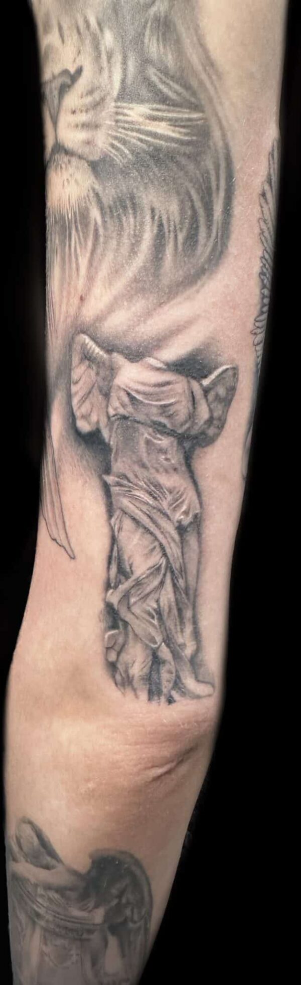 healed statue tattoo