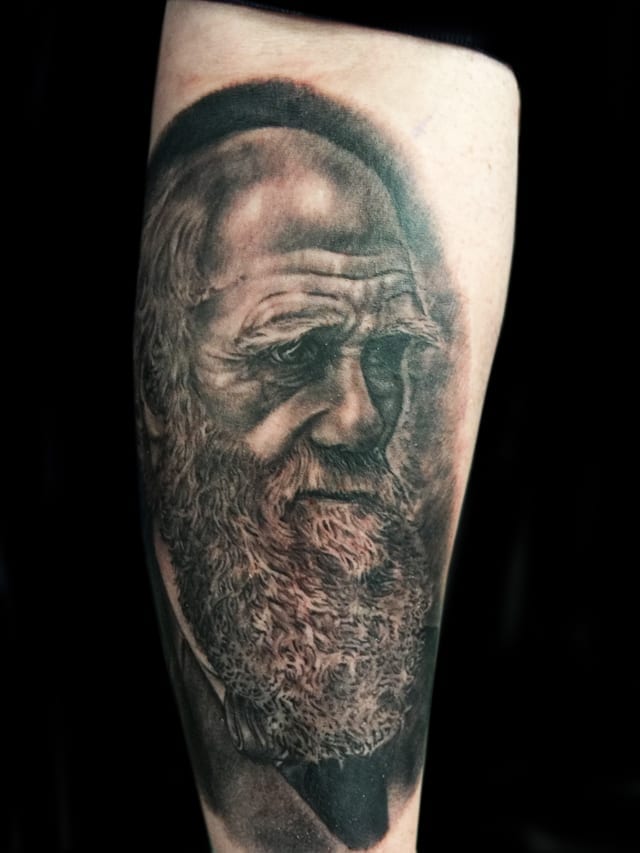 black and grey portrait tattoo