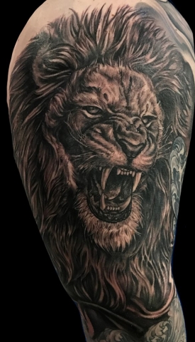 realistic lion portrait tattoo