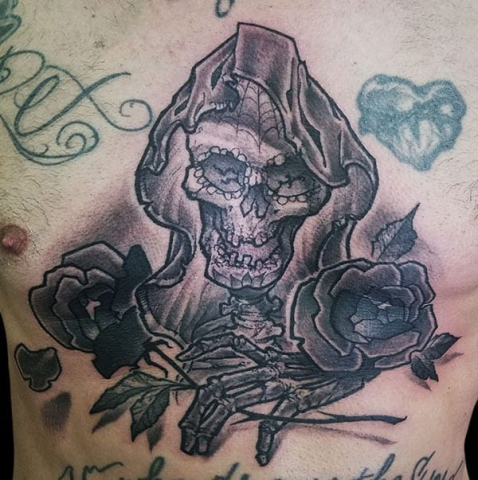 skull flower sternum tattoo