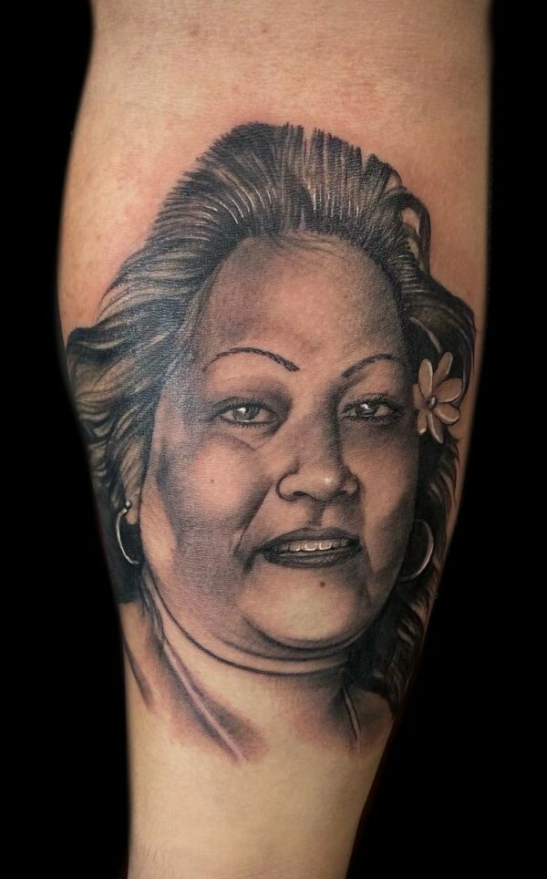 black and grey portrait tattoo