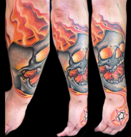Skull in flames tattoo