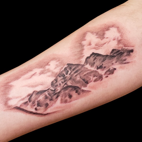 black and grey mountain realistic tattoo