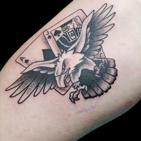 Traditional eagle and playing card tattoo