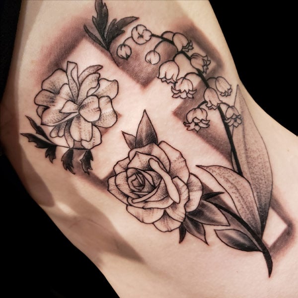 negative cross and flower tattoo