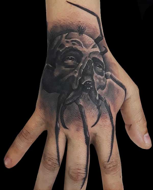 realistic skull spider hand tattoo