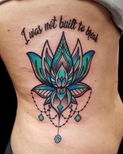 lotus and lettering tattoo