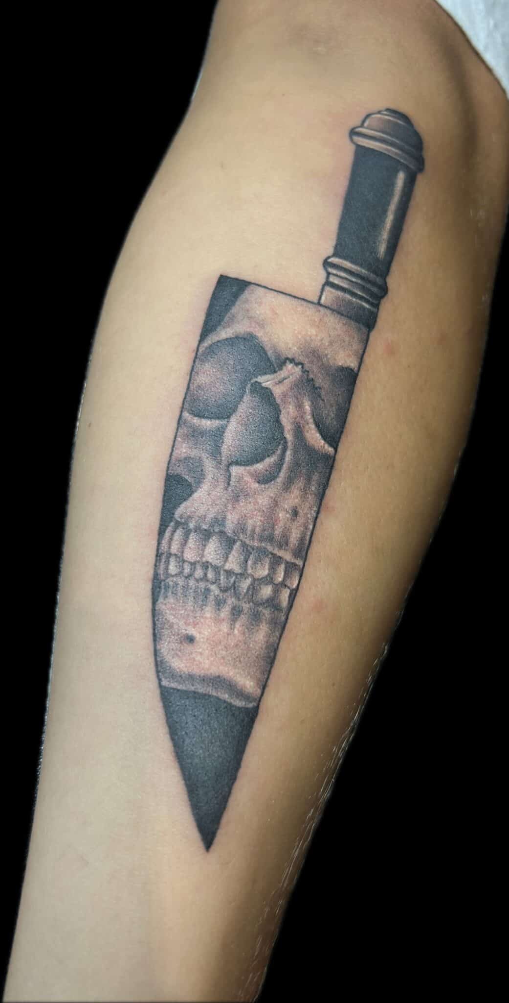 chef's knife with realistic skull tattoo
