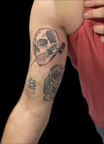 linework inner bicep skull tattoo