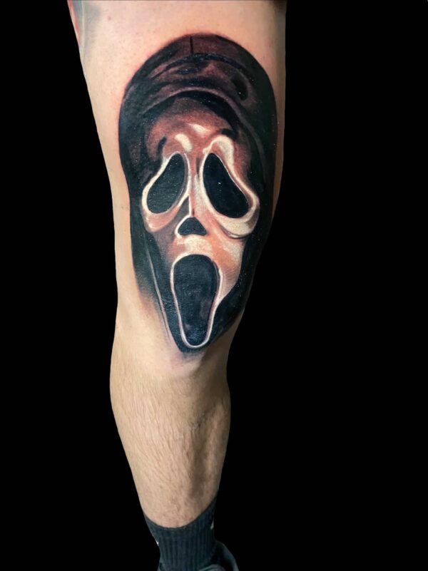 scream face tattoo, knee tattoo