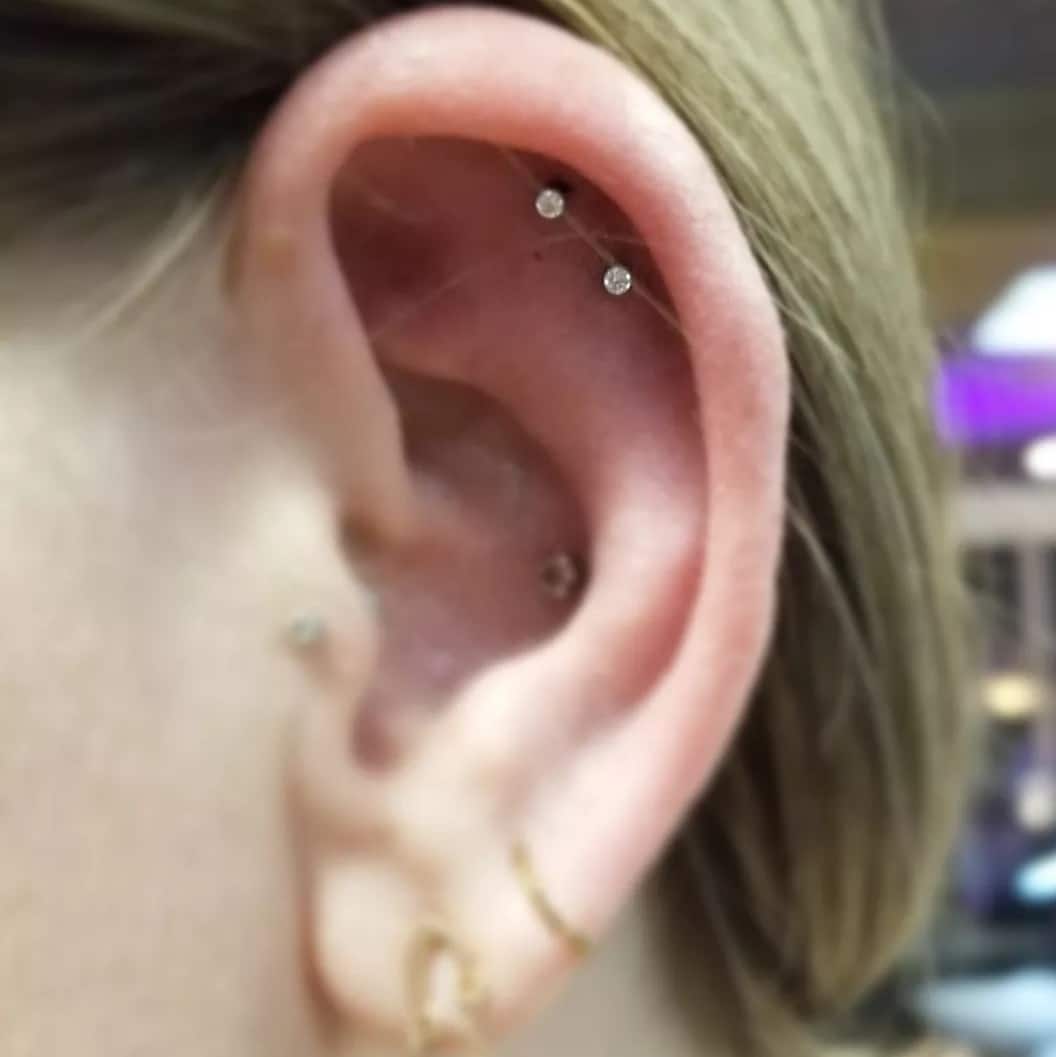 Double helix piercings, doubled, Savvy, Piercer at Revolt Tattoos in Lake Tahoe