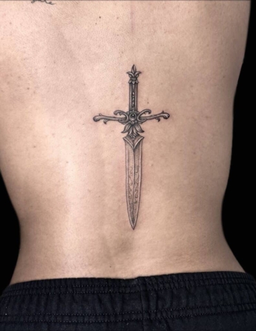 Dagger on back tattoo 